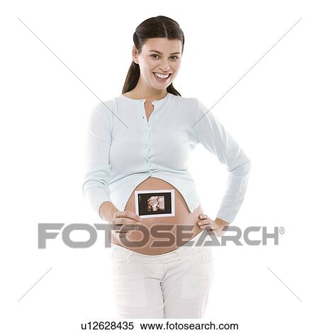 Pregnant woman holding her baby scan View Large Photo Image Stock Photography - Pregnant woman holding her baby scan. Fotosearch