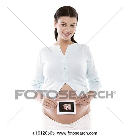 Pregnant woman holding her baby scan View Large Photo Image Stock Photography - Pregnant woman holding her baby scan. Fotosearch