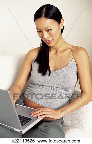 Pregnant woman using laptop View Large Photo Image Stock Photograph - Pregnant woman using laptop. Fotosearch