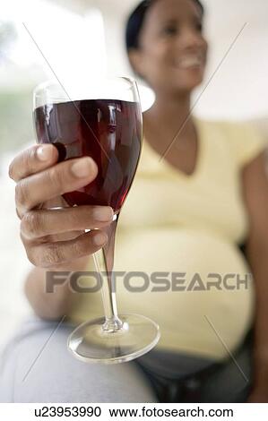 Pregnant woman with a glass of red wine View Large Photo Image Stock Image - Pregnant woman with a glass of red wine. Fotosearch
