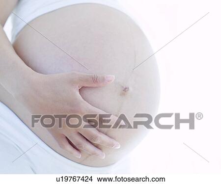 Picture - Pregnant woman's abdomen. Fotosearch