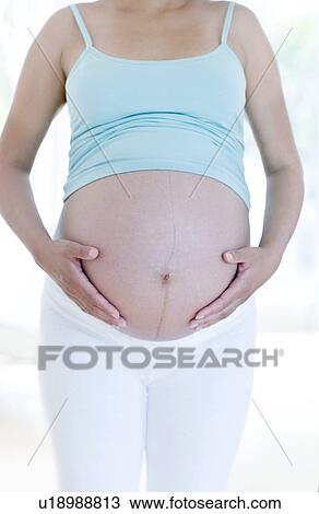 Pregnant woman's abdomen View Large Photo Image Stock Image - Pregnant woman's abdomen. Fotosearch