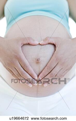 Stock Image - Pregnant woman's abdomen. Fotosearch