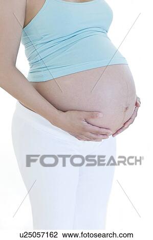 Stock Image - Pregnant woman's abdomen. Fotosearch
