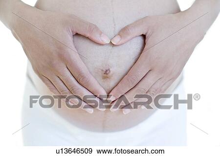 Stock Photo - Pregnant woman's abdomen. Fotosearch