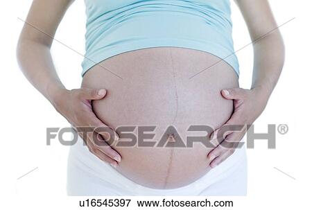 Stock Photo - Pregnant woman's abdomen. Fotosearch