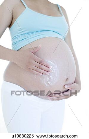 Stock Photography - Pregnant woman's abdomen. Fotosearch