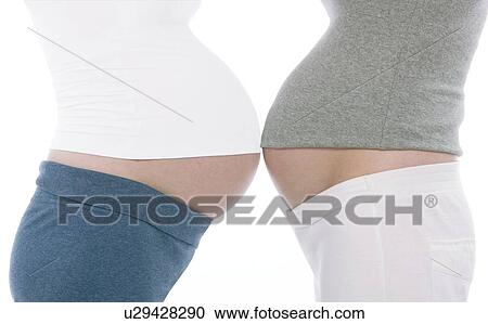 Stock Image - Pregnant women's abdomens. Fotosearch