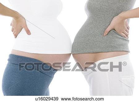 Stock Photo - Pregnant women's abdomens. Fotosearch