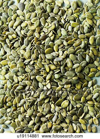 Stock Image - Pumpkin seeds, full frame, close-up. Fotosearch