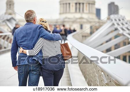 Rear view of mature dating couple crossing Millennium Bridge, London, UK View Large Photo Image Stock Photograph - Rear view of mature dating couple crossing Millennium Bridge, London, UK. Fotosearch