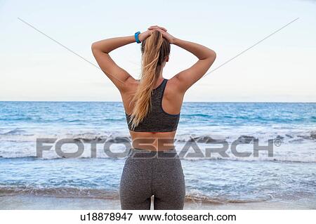 Rear view of young female runner on beach, Dominican Republic, The Caribbean View Large Photo Image Stock Photo - Rear view of young female runner on beach, Dominican Republic, The Caribbean. Fotosearch