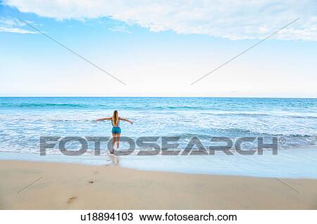 Rear view of young woman running into sea, Dominican Republic, The Caribbean View Large Photo Image Stock Image - Rear view of young woman running into sea, Dominican Republic, The Caribbean. Fotosearch