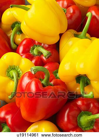 Stock Image - Red and yellow bell peppers, full frame, close-up. Fotosearch