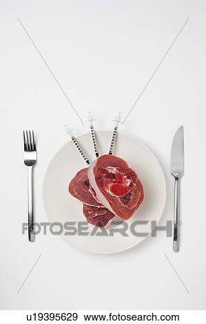Red meat with syringes on a white plate View Large Photo Image Stock Photo - Red meat with syringes on a white plate. Fotosearch