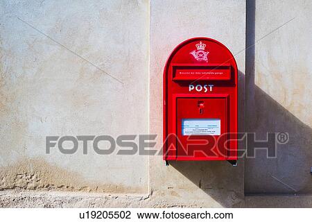 Stock Image - Red postbox on wall, Copenhagen, Denmark. Fotosearch