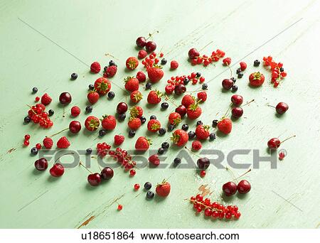 Red summer fruits on green background View Large Photo Image Picture - Red summer fruits on green background. Fotosearch