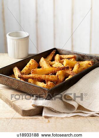 Roast parsnips with crispy seasoning in tray View Large Photo Image Stock Photo - Roast parsnips with crispy seasoning in tray. Fotosearch