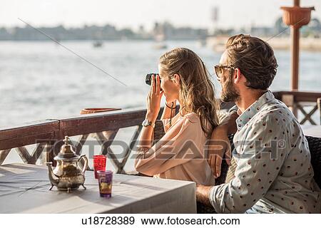 Romantic couple photographing from Dubai marina cafe, United Arab Emirates View Large Photo Image Stock Photo - Romantic couple photographing from Dubai marina cafe, United Arab Emirates. Fotosearch