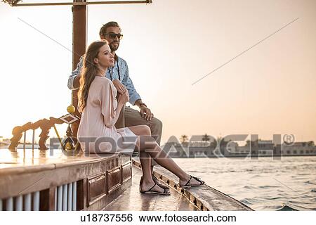 Romantic couple watching from boat at Dubai marina, United Arab Emirates View Large Photo Image Stock Photograph - Romantic couple watching from boat at Dubai marina, United Arab Emirates. Fotosearch