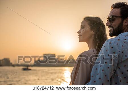 Romantic couple watching sunset at Dubai marina, United Arab Emirates View Large Photo Image Stock Image - Romantic couple watching sunset at Dubai marina, United Arab Emirates. Fotosearch