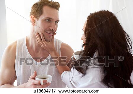 Romantic young couple face to face on bed View Large Photo Image Stock Photo - Romantic young couple face to face on bed. Fotosearch