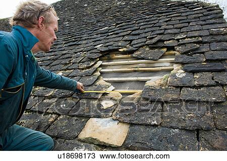 Roofer measuring hole in traditional stone tile roof View Large Photo Image Stock Image - Roofer measuring hole in traditional stone tile roof. Fotosearch
