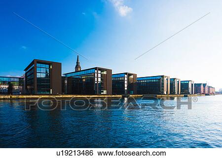 Stock Photograph - Rows of office building on river waterfront, Copenhagen, Denmark. Fotosearch