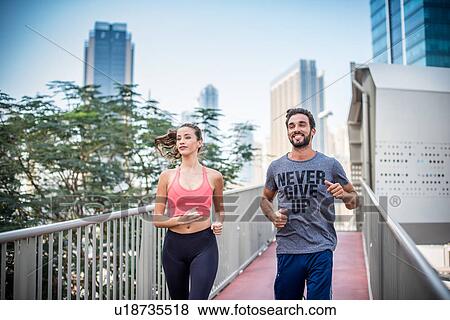 Running couple running on footbridge, Dubai, United Arab Emirates View Large Photo Image Stock Photo - Running couple running on footbridge, Dubai, United Arab Emirates. Fotosearch