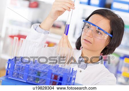 Scientist holding a test tube View Large Photo Image Picture - Scientist holding a test tube. Fotosearch