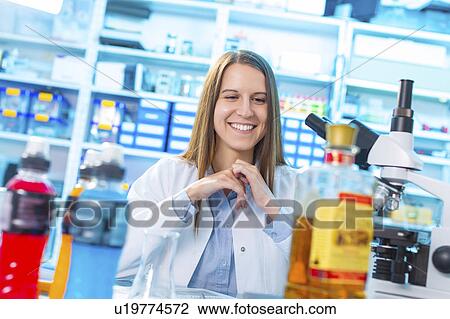 Stock Image - Scientist in lab, smiling. Fotosearch