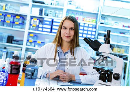 Scientist in lab with microscope View Large Photo Image Picture - Scientist in lab with microscope. Fotosearch