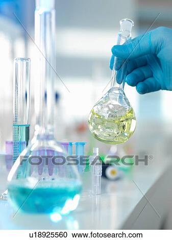 Scientist preparing a chemical formula in a conical flask during an experiment in the laboratory View Large Photo Image Stock Image - Scientist preparing a chemical formula in a conical flask during an experiment in the laboratory. Fotosearch