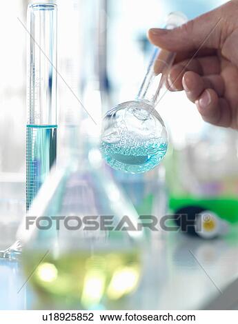 Scientist preparing a chemical formula in a conical flask during an experiment in the laboratory View Large Photo Image Stock Image - Scientist preparing a chemical formula in a conical flask during an experiment in the laboratory. Fotosearch