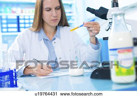 Stock Image - Scientist testing milk sample. Fotosearch