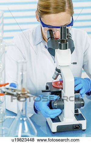 Scientist using microscope View Large Photo Image Stock Photo - Scientist using microscope. Fotosearch