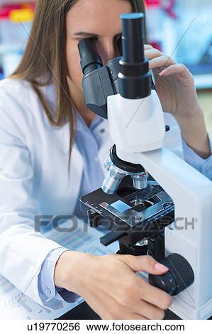 Scientist using microscope View Large Photo Image Stock Photograph - Scientist using microscope. Fotosearch