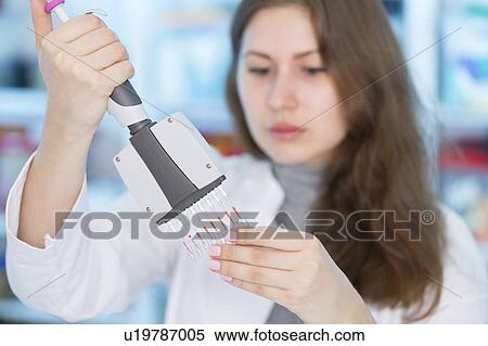 Stock Photography - Scientist using multi pipette. Fotosearch