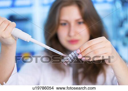 Picture - Scientist using pipette and micro tubes. Fotosearch