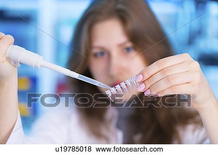 Stock Photo - Scientist using pipette and micro tubes. Fotosearch
