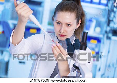 Stock Photo - Scientist using pipette. Fotosearch
