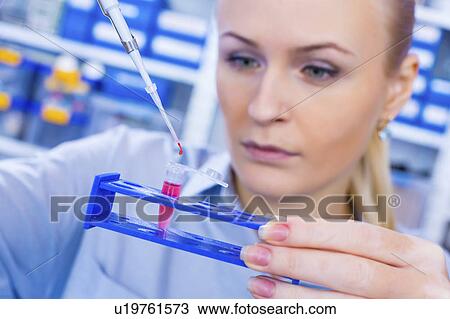 Stock Image - Scientist with an eppendorf tube. Fotosearch