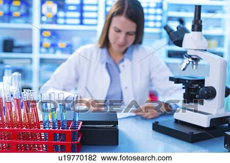 Stock Image - Scientist working in a lab. Fotosearch