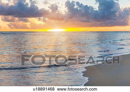 Stock Photo - Seascape with sunrays at sunset, Dominican Republic, The Caribbean. Fotosearch