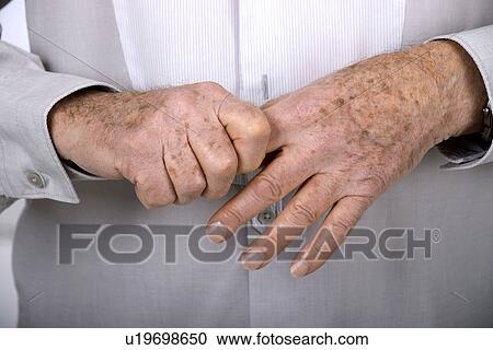Senior man holding his finger View Large Photo Image Stock Image - Senior man holding his finger. Fotosearch