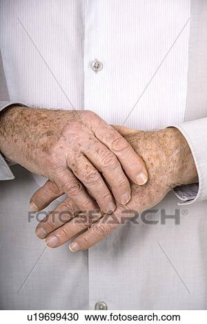 Stock Image - Senior man holding his hand. Fotosearch