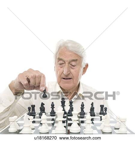 Stock Image - Senior man playing chess. Fotosearch