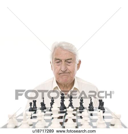 Stock Photo - Senior man playing chess. Fotosearch