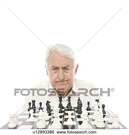 Stock Photograph - Senior man playing chess. Fotosearch