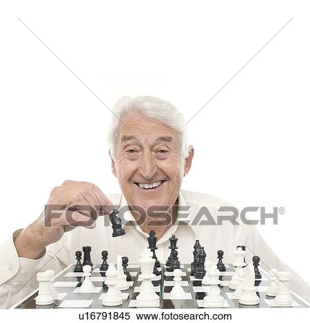 Stock Photography - Senior man playing chess. Fotosearch